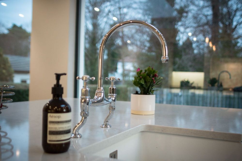Perrin & Rowe Bridge Mixer over Belfast sink with Lagoon Silestone Quartz