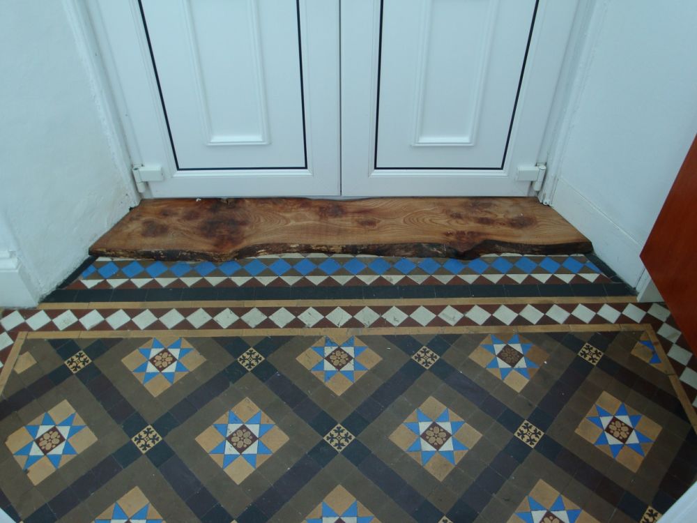 Slice of Elm with bark. Used this to hide damaged geometric tiles in utility area